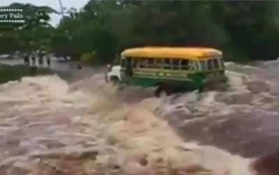 A bus carrying people was caught in a water torrent during a flood