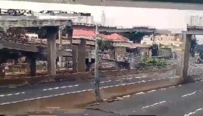 Concrete Boom trucks hits overpass and knocks it over itself.