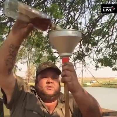 Dude chugs an entire bottle of Bourbon through funnel 