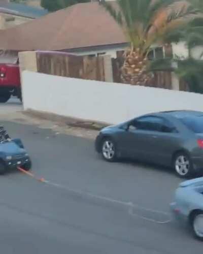 WCGW riding in a Fisher Price pulled by a real car