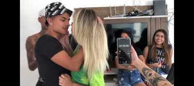 Brazilian guy french kisses sexy blonde girl in front of friends