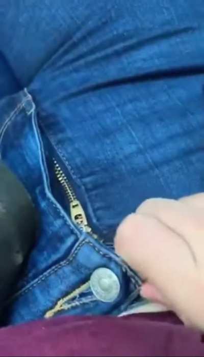 Unbuckling black belt and unzipping my tight blue jeans seated with one hand