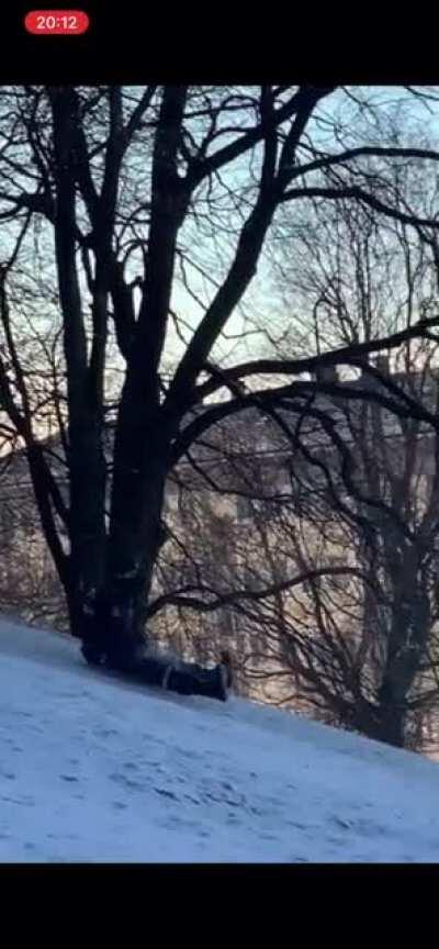 Police in riot gear go sledding