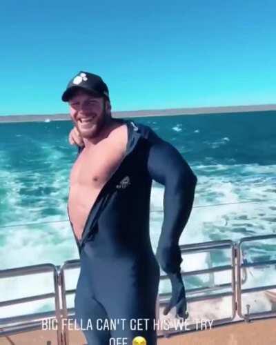 Matt O'Reilly trying (and failing) to take off his wetsuit
