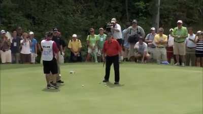 Jack Nicklaus shows Johnny Miller how to putt from 102 feet away, after Miller tried to use a wedge