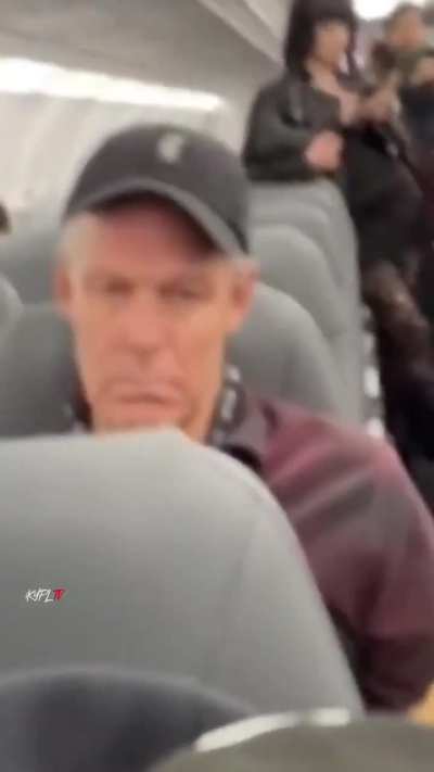 Guy starts filming the passenger behind him