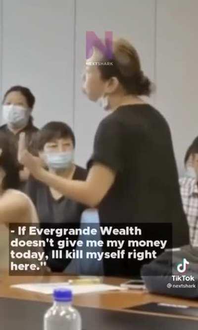 Chaos escalates in evegrande as investor threatens to harm themselves with a knife during meeting