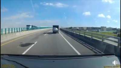 Styrofoam box jumps out and back of the truck, twice