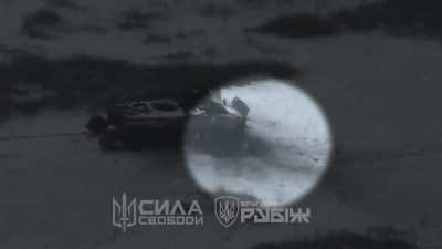 Russian soldier laying underneath a BMP is hit with an Ukrainian drone. February 2025