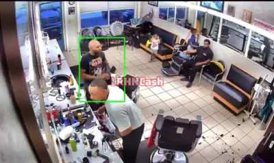 Guy in a work uniform pulls out a gun on a barber in front of kids over a pushed back hairline