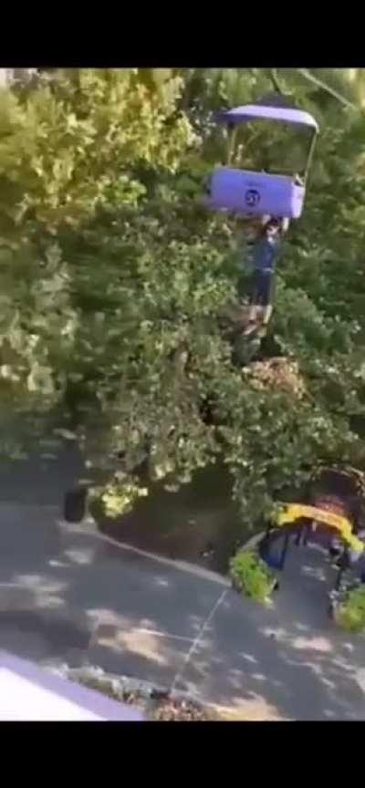 Man at amusement park hanging from sky ride. The news said he was very intoxicated. He fell 50 feet and is in critical condition