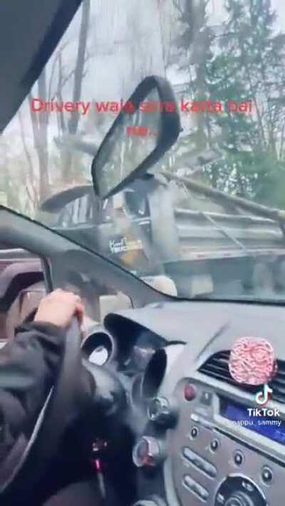 Richmond based Kam Bhullar trucking casually dragging a log and power line down the road in to oncoming traffic