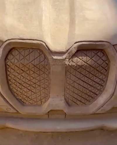 An M5 scale model is crafted by a sand sculptor