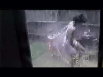 Kid sprays mom with a hose