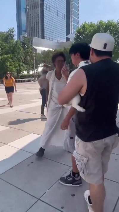 A woman freaks out over a bunny near The Bean in Chicago, Illinois