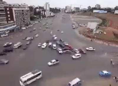 Behold the bustling streets of Ethiopia's busiest intersection, where a mesmerizing dance of vehicles and pedestrians unfolds without the conventional aid of traffic lights! 🚘🚶‍♀️✨