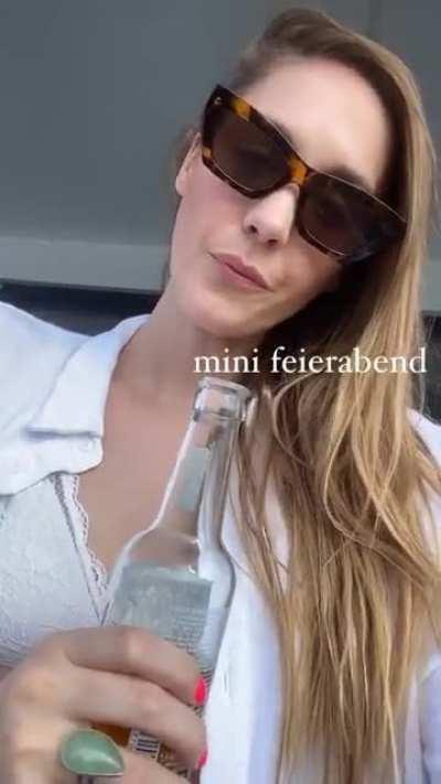 Enjoying her bevvy on the terrace