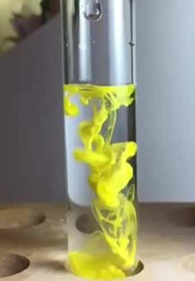 A solution of lead (II) nitrate is dropped into a solution of potassium iodide, forming a brilliant yellow lead (II) iodide precipitate