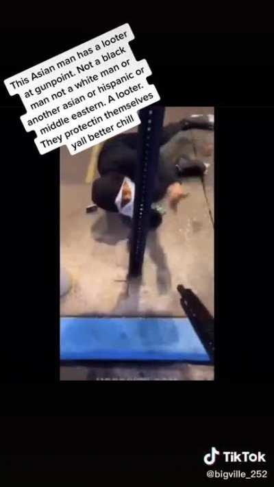 Man protecting his shop from looter