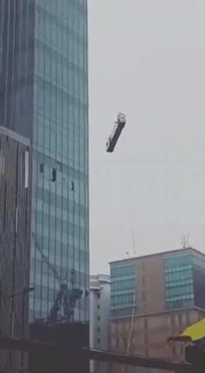 Workers trapped in a gondola losing control due to strong wind