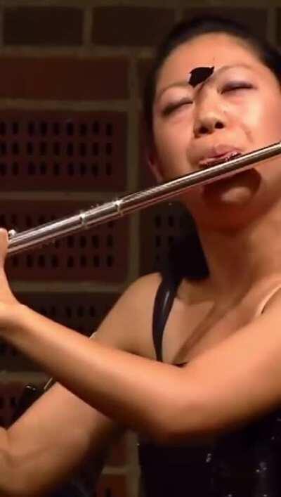 A butterfly landed on flutist Yukie Ota's face during a flute recital