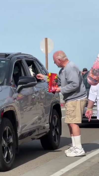 This man sits here with a bag of treats, waiting for dogs to show up, just to feed them. ❤️