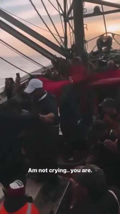 Moroccan fishermen celebrating their country's qualification to the Semi-final.