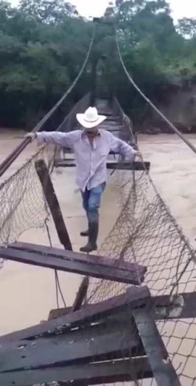Man crossing river during the Iota hurricane floodings in Honduras. Sorry for potato quality