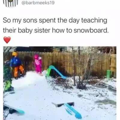 Big bros successfully teaching little sis to snowboard