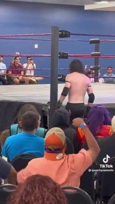 Peter Griffin doing a Dominator at an anime convention while Misato watches from the front row.