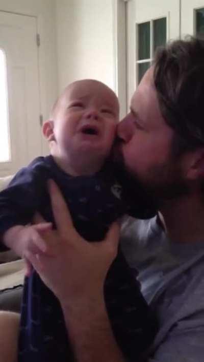Dad calms blind and deaf son with a kiss