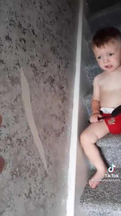 Kid eats his Mothers new wallpaper.