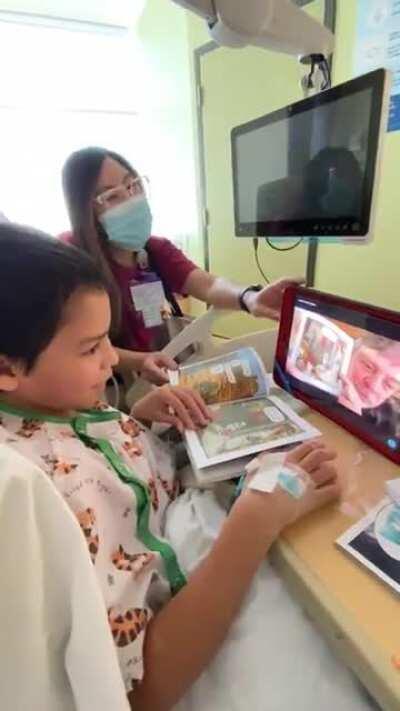 Mark Hamill reading some Star Wars comics to a child at a children's hospital.