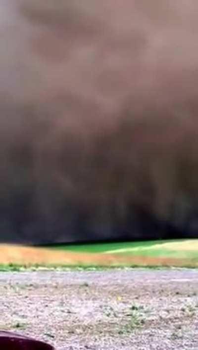 A tornado touches down close to a couple of guys fishing