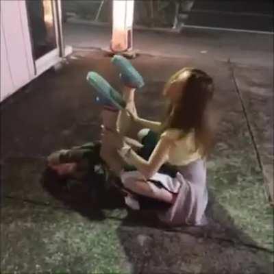 Two Japanese girls dry humping on the ground