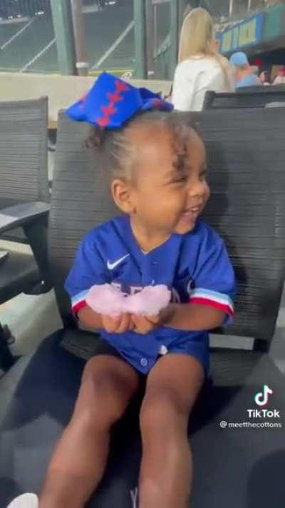 Little girl trying cotton candy for the first time