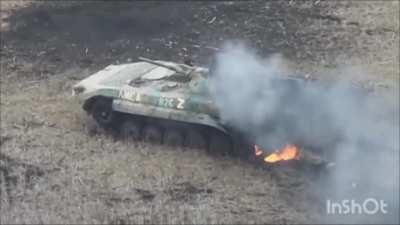 video showing a russian BMP-1 being hit by an ATGM missile then later being destroyed by a drone dropping a grenade through the gunner hatch. [music from source]