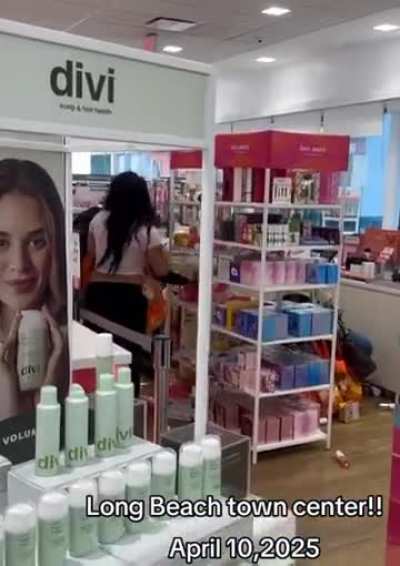 Group of people stealing from a makeup store
