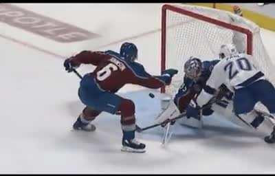 He pushes it forward then deflects it around the skate into the net.