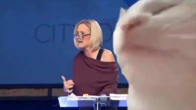 Trump voodoo high priestess chanting in tongues. Someone put a lit techno cat over it. Makes it much better.