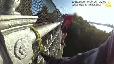NYPD officer breaks down after he talked man down from the side of a bridge. 