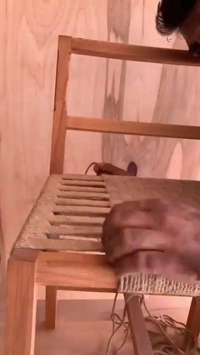 This man restoring a chair, with some little helpers. 