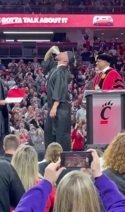 Travis Kelce slams a beer as he accepts his college diploma