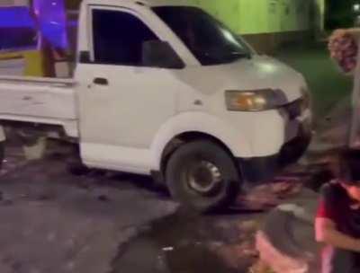 group of people at a outdoor table are hit by a car