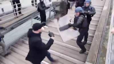 It's like Tekken: he fights riot police and pushes them back with his fists.