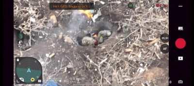 Russians digging in a hole, while one fire. Benny hill from source.