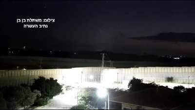 HD Surveillance camera footage from Netiv Haasara shows a large barrage of rockets being launched from northern Gaza, followed by a massive blast on Gaza Hospital [0:29s]