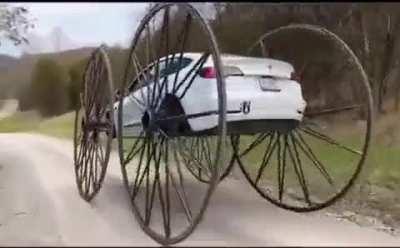 Someone put 10 feet wheels on a Tesla