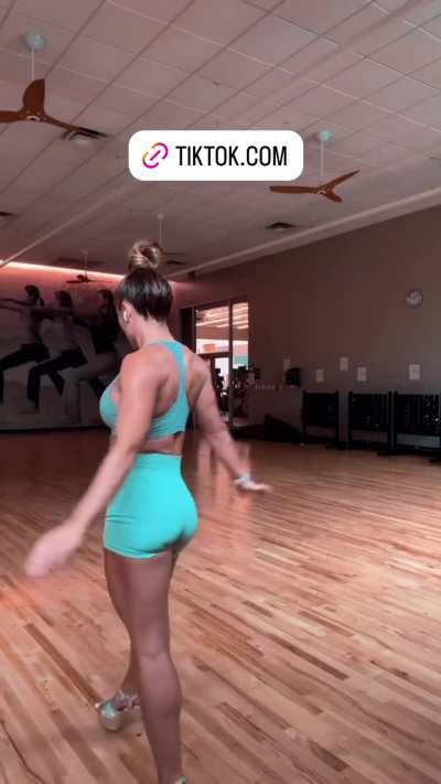 Mandy Rose walking in blue gym gear 