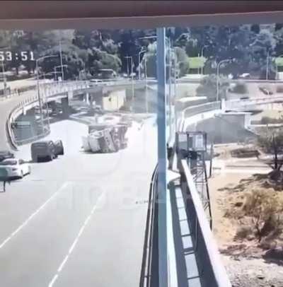 Truck rolls over after going too fast on a bridge on-ramp